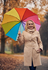 Senior woman in park in autumn