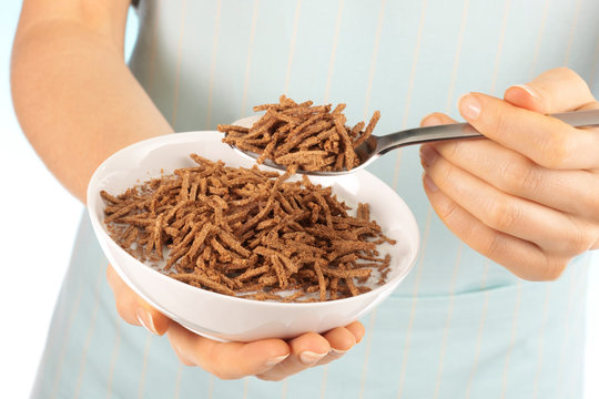 WOMAN EATING ALL-BRAN BREAKFAST CEREAL
