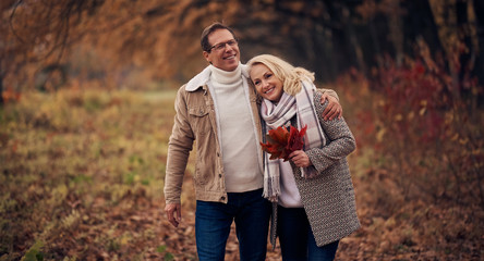 Senior couple in park in autumn