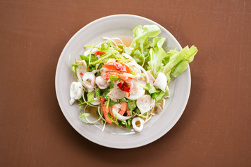 Thai Spicy salad with cuttlefish., shrimp, fish and vegetable