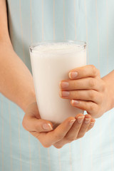 WOMAN HOLDING GLASS OF MILK