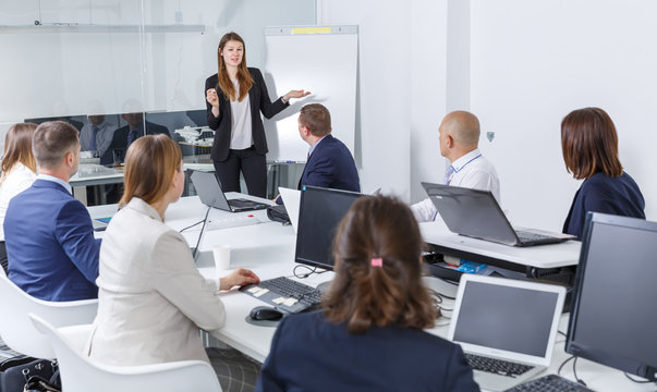  businesswoman making presentation to colleagues