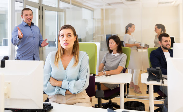 Dissatisfied manager talking to woman