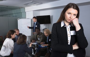 Portrait of upset woman in boardroom