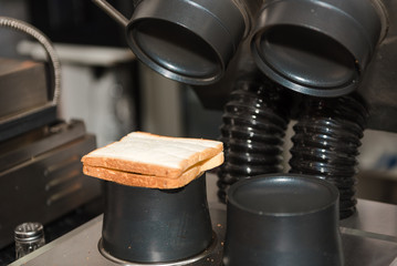 Cooking hot sandwich on special equipment in a restaurant or cafe. Fast food.
