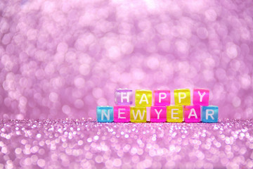 New year 2019 violet sparkle glittery shiny background with blurred bokeh lights. Merry christmas and happy new year holiday card with colorful plastic letters. Amazing backdrop