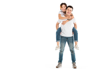 cheerful husband giving piggyback ride to happy wife isolated on white