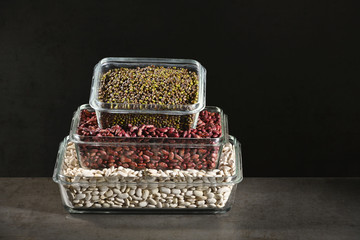 White beans, red beans mung bean in glass bowls on a dark background. Eco friendly, plastic free items.