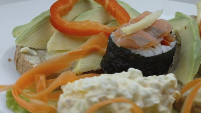 A Plate of Avocado, Suchi and Salad Toast Spinning