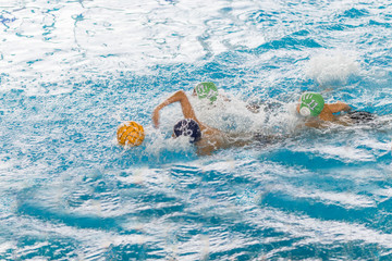 water polo competition in a pool for children and adolescents. water sports and swimming pool championship. © Ivan