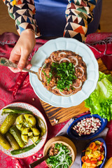 Lobio - traditional Georgian dish with red beans, cilantro, ajika spice served with pickles vegetables. Vegan vegetarian healthy food