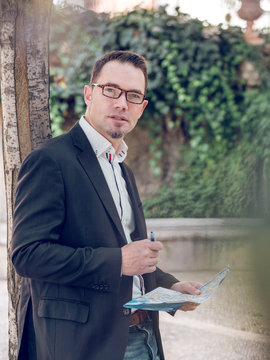 Businessman making notes on map