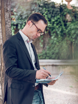 Businessman making notes on map