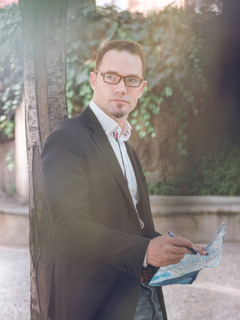 Businessman making notes on map