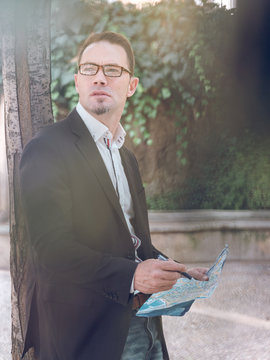 Businessman making notes on map