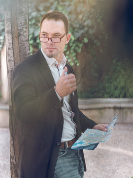 Businessman making notes on map
