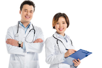 Fototapeta premium female doctor with diagnosis and male doctor with crossed arms looking at camera isolated on white