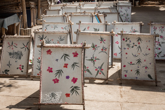 Process of making flowers added paper, propped to dry in the sun