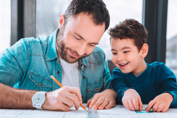 Brunette man sitting next to the table