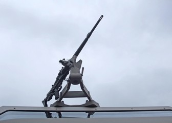 closeup of a machine gun on top of a vehicle roof  