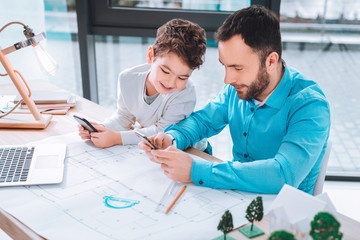 Joyful dad and son having fun together