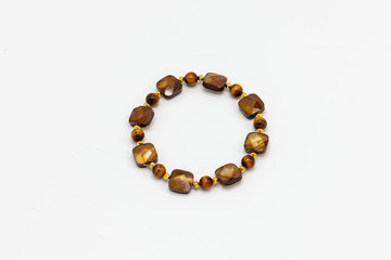 multiple colored and sized beads bracelet on white background