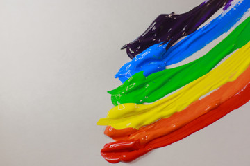 multi-colored paint on a white background smeared in a line