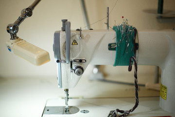 seamstress workplace. Sewing machine scissors threads and other tools. Tailoring industry
