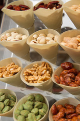 Display of take away tapas cones, filled with different nuts like almonds, pictache and walnuts. Marbella, Costa del Sol, Spain.