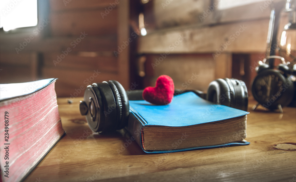 Wall mural bible with a red heart and earphone on wooden table. concept for obedience of god. - Wall murals