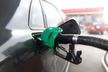 Fueling car with petrol pump at a gas station. Petrol station. Gasoline and oil products. Close up.