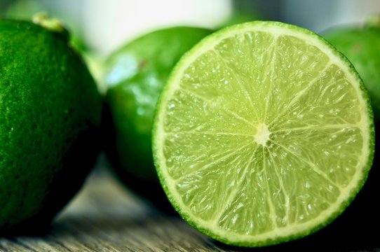 lime slices on wooden table. Detox diet, limes Backgrounds, Close up shot, fruit macro photography