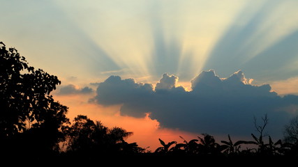 Beautiful sunset after a  setting with bright sunrays shinning through the clouds