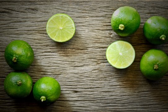 limes slices on wooden table. Detox diet, fresh lime Background, Close up shot, fruit macro photography