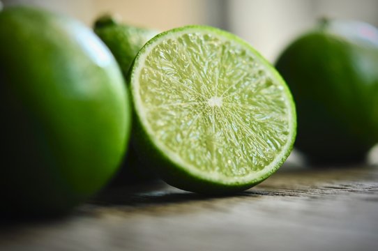 limes slices on wooden table. Detox diet, fresh lime Background, Close up shot, fruit macro photography