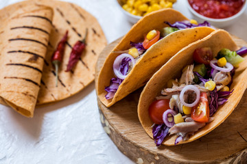 Tacos Mexican food with meat, fresh vegetables and salsa sauce on white background
