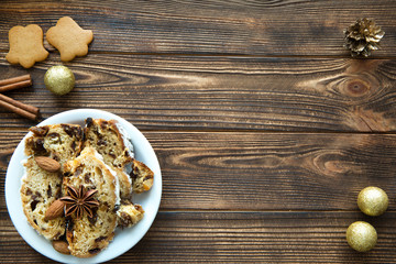 Christmas cake and gingerbread cookie on brown table. Top view. Space for text.