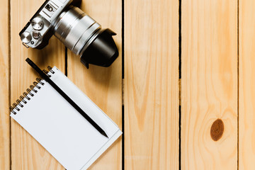 Camera on wooden background.