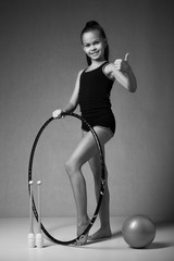 Teenager girl involved in rhythmic gymnastics with gymnastic hoop  © Rakursstudio