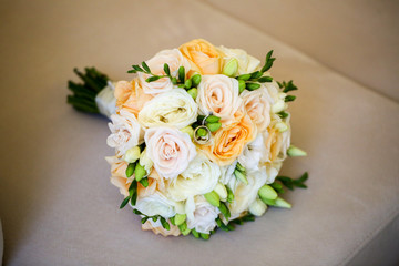 Close up with beautiful bouquet of flowers and rings