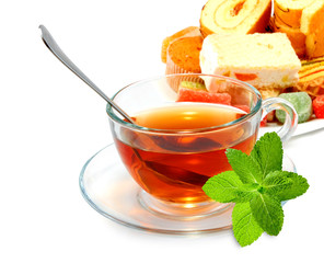image of a cup with tea, mint leaves and sweets