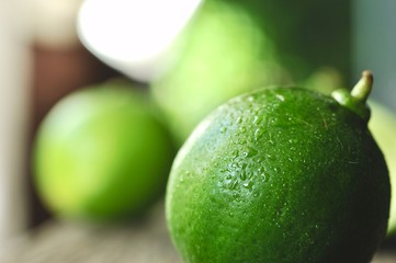 limes slices on wooden table. Detox diet, fresh lime Background, Close up shot, fruit macro photography
