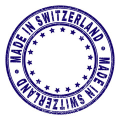 MADE IN SWITZERLAND stamp seal watermark with grunge texture. Designed with circles and stars. Blue vector rubber print of MADE IN SWITZERLAND tag with grunge texture.