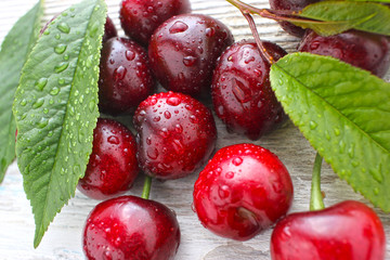 fresh red berries with green leaves background,  on white background. Healthy food.