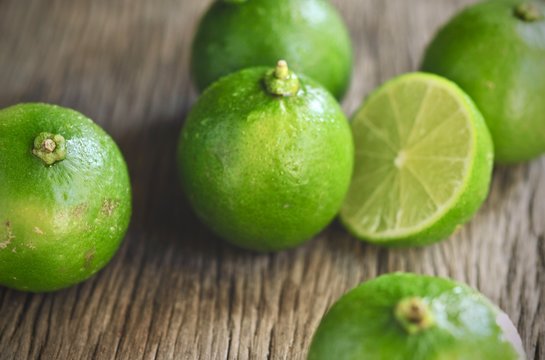 limes slices on wooden table. Detox diet, fresh lime Background, Close up shot, fruit macro photography