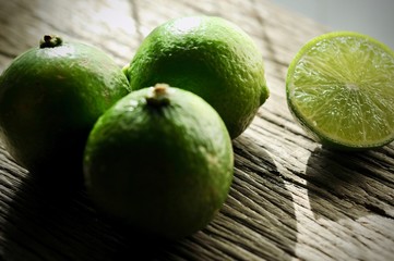 limes slices on wooden table. Detox diet, fresh lime Background, Close up shot, fruit macro photography