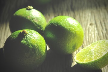 limes slices on wooden table. Detox diet, fresh lime Background, Close up shot, fruit macro photography