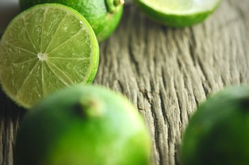 limes slices on wooden table. Detox diet, fresh lime Background, Close up shot, fruit macro photography