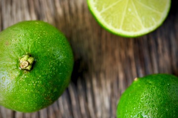limes slices on wooden table. Detox diet, fresh lime Background, Close up shot, fruit macro photography
