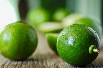 limes slices on wooden table. Detox diet, fresh lime Background, Close up shot, fruit macro photography